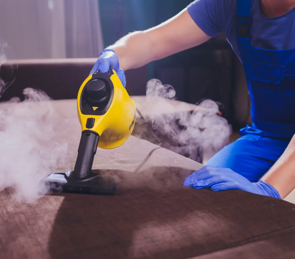 dry_cleaner_s_employee_removing_dirt_from_furniture_flat_closeup